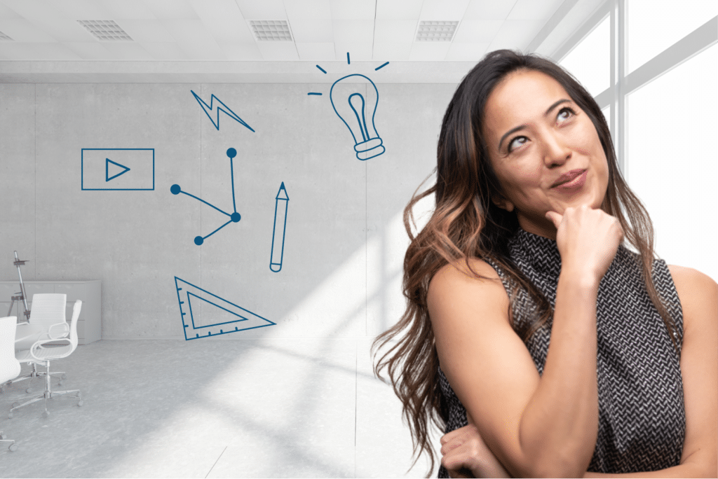 woman brainstorming by the window of a meeting room